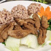veggie pork and mixed vegetables on a plate with rice