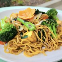 noodles and vegetables on a white plate