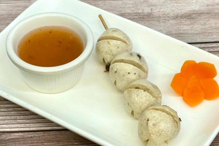 Vegan mushroom balls appetizers on a plate with sauce.