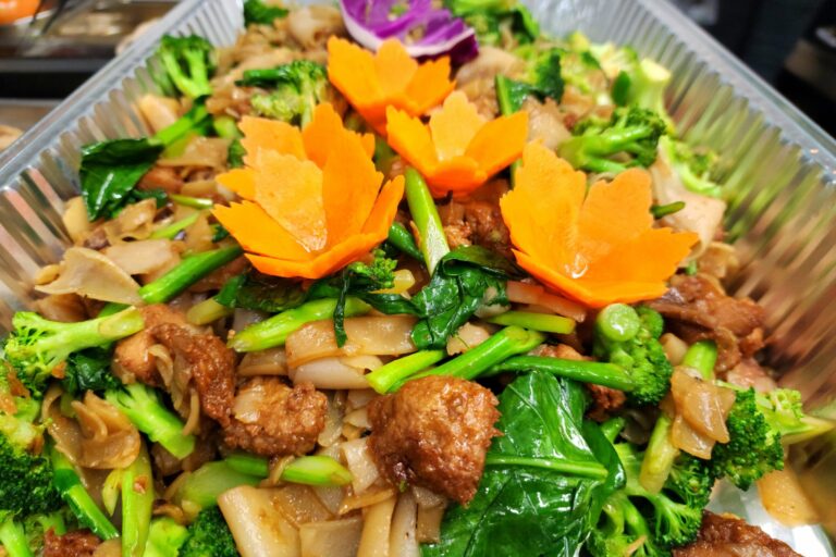 large aluminum tray of cooked rice noodles