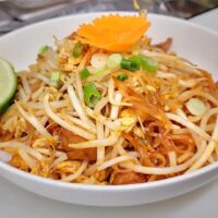 rice noodles topped with bean sprouts on a plate