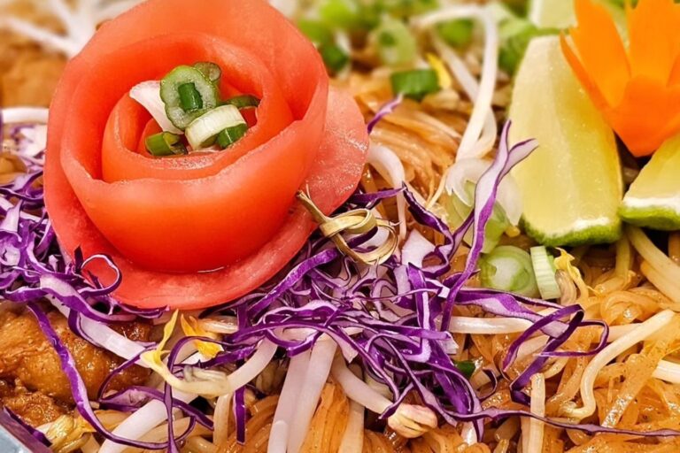 tomato decoration on a tray of noodles
