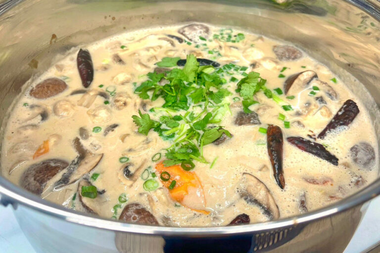 Party tray of Tom Kha soup in a big bowl.