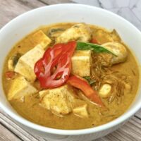 tofu and glass noodles in red curry in a bowl