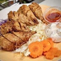 Fried vegan chicken drumsticks on a plate