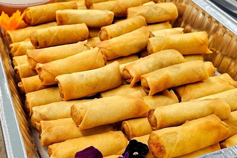 spring rolls in a large aluminum tray