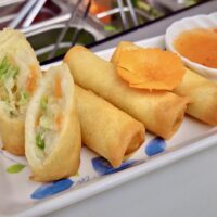 Fried veggie spring rolls on white plate