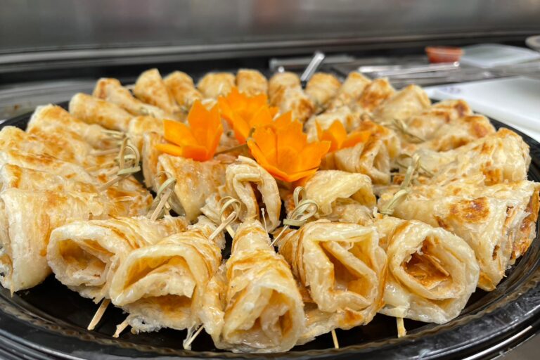 rolled flat bread on a black tray
