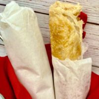 rolled roti wrapped in white sandwich paper